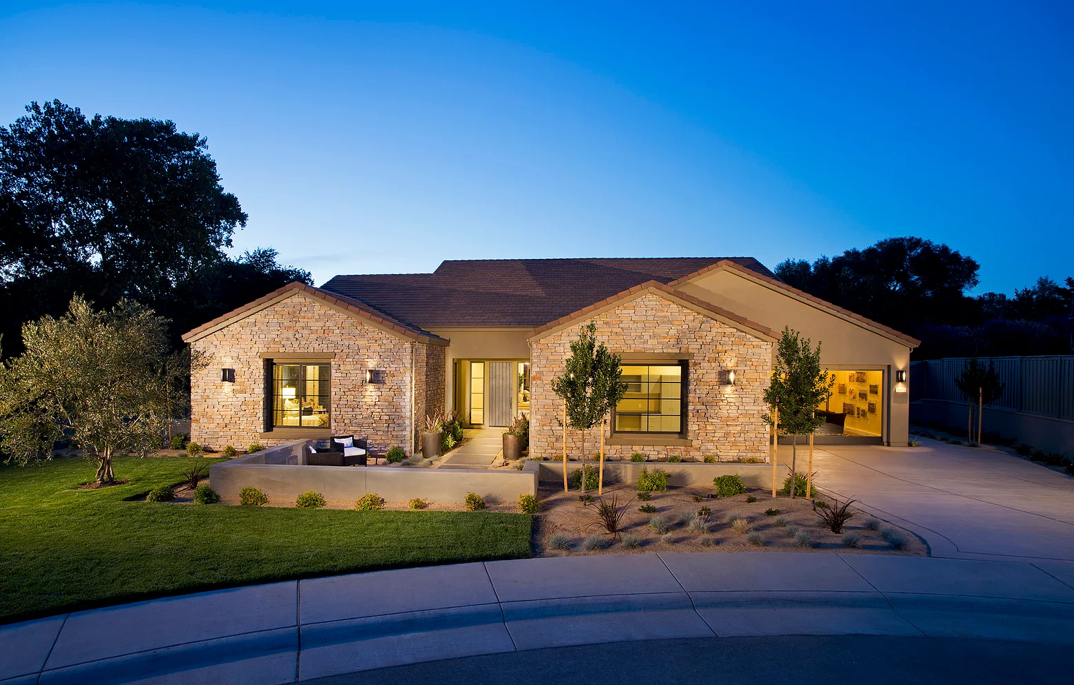 The view of a beautiful new home from the sidewalk.